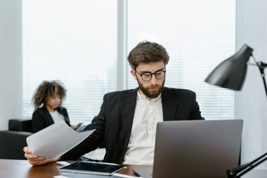 a man sitting at the desk analysing