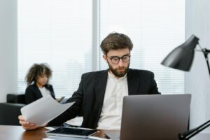 a man sitting at the desk analysing