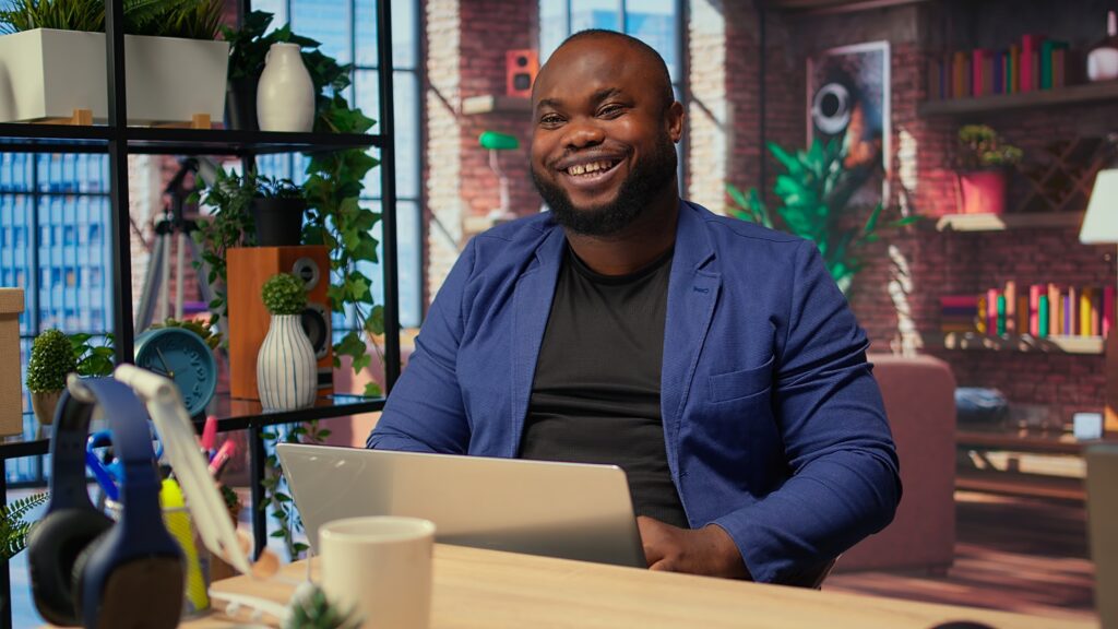 teleworker at home office editing documents on his personal laptop