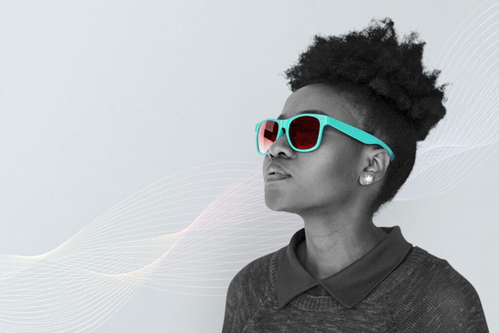 black woman wearing a teal sunglasses