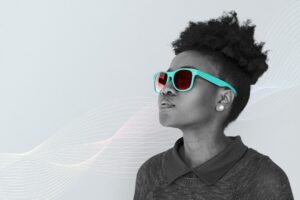 black woman wearing a teal sunglasses