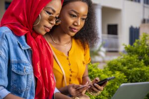 Home african females shopping online while sitting in a park