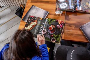 A woman holding a beautiful menu. Menu Psychology is powerful