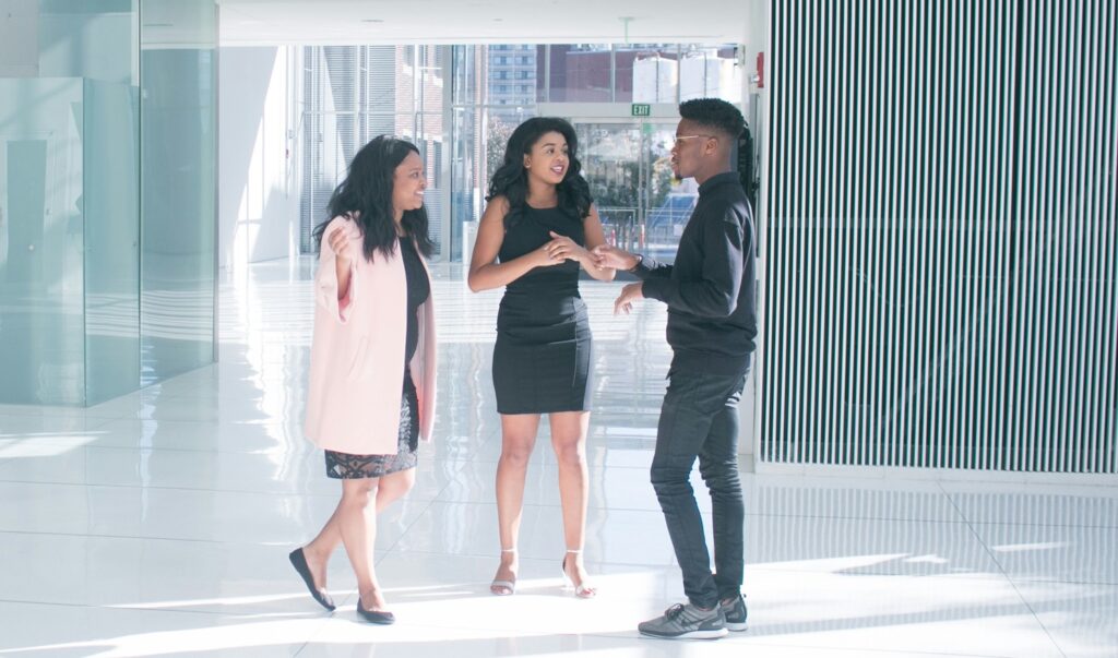 young man talking to two ladies, nurturing warm leads