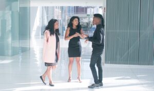 young man talking to two ladies, nurturing warm leads